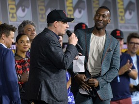 President of Marvel studios Kevin Feige, centre, welcomes actor Mahershala Ali on stage during the Marvel panel during Comic Con in San Diego, Calif., on July 20, 2019. (CHRIS DELMAS/AFP/Getty Images)