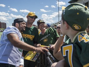 Calvin McCarty and coach Jason Maas get together for a photo at Eskimos Fan Day at Clark Park.