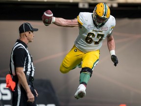 Edmonton Eskimos' Colin Kelly celebrates teammate Trevor Harris' touchdown during first half CFL football action against the B.C. Lions, in Vancouver, on Thursday, July 11, 2019.