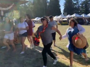 People run as an active shooter was reported at the Gilroy Garlic Festival, south of San Jose, Calif., on Sunday, July 28, 2019 in this still image taken from a social media video.