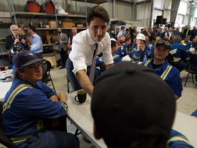 Prime Minister Justin Trudeau speaks with workers at Kinder Morgan’s TransMountain pipeline terminal in Edmonton on July 12, 2019. Photo by Ian Kucerak / Postmedia