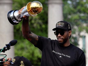 Kawhi Leonard hold his MVP trophy during the Raptors victory parade in Toronto June 17, 2019. (REUTERS/Moe Doiron)