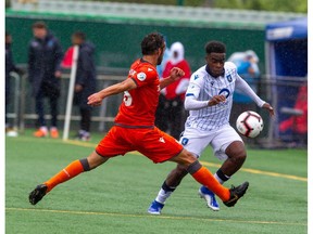 Forge midfielder Fano, Giuliano makes a tackle on FC Edmonton midfielder Allan Zebie at Clarke Field on July 27, 2019.