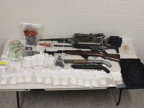 The Red Deer RCMP and Sylvan Lake RCMP in a joint investigation that led to the arrest of three people and the seizure or drugs, cash, weapons and three hand grenades.Images supplied.