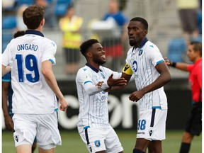 FC Edmonton's Tomi Ameobi (18) scores on HFX Wanderers FC's goalkeeper Christian Oxner (50) on a penalty kick during the second half of a Canadian Premier League soccer game at Clarke Stadium in Edmonton, on Wednesday, July 31, 2019.