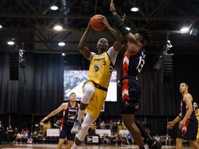 Edmonton Stingers' Mamadou Gueye (3) scores past Fraser Valley Bandits' Jamal Ray (13) during a CEBL game at Northlands Expo Centre in Edmonton, on Thursday, Aug. 1, 2019. Photo by Ian Kucerak/Postmedia