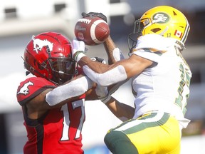 Calgary Stampeders Markeith Ambles battles Edmonton Eskimos Arjen Colquhoun for the ball in first half CFL action at McMahon stadium in Calgary on Saturday, August 3, 2019.
