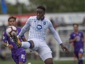 Mele Temguia of FC Edmonton controls the ball as Jose Hernandez of Pacific FC closes in at Clark Field in Edmonton on Saturday, Aug. 10, 2019.