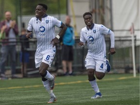 Led by Oumar Diouck, 45, of FC Edmonton, celebrates a first half goal on Pacific FC at Clark Field in Edmonton on August 10, 2019.
