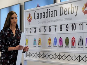 Marina Law (Marketing Manager, Century Mile Racetrack and Casino) posts the order on the post position draw board for the 90th running of the Canadian Derby at Century Mile Racetrack on Wednesday August 14, 2019.