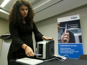 Einat Velichover, Business Development Manager, Draeger Safety Canada, demonstrates the company's Draeger DrugTest 5000 oral drug testing device during a press conference at the Edmonton Convention Centre in Edmonton, on Wednesday, Aug. 21, 2019. Photo by Ian Kucerak/Postmedia