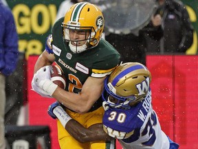 Edmonton Eskimos Greg Ellingson is tackled by Winnipeg Blue Bomber Winston Rose during Canadian Football League game action in Edmonton on Friday August 23, 2019.