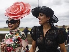 Laura Dreger, left, and Sue Jaksich take in the races at the Canadian Derby at the Century Mile, in Edmonton August 18, 2019.