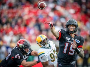 Calgary Stampeders throws under pressure from Kwaku Boateng of the Edmonton Eskimos during the Labour Day Classic in Calgary on Monday, September 3, 2018.