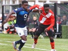 Edmonton FC Jeannot Esua (L) competes along the line for a loose ball against Cavalry FC Nathan Mavila during CPL soccer action between Cavalry FC and FC Edmonton at ATCO Field at Spruce Meadows in Calgary on Friday, August 16, 2019.