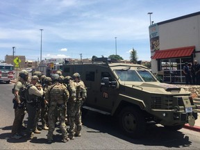 Armed Policemen gather next to an FBI armoured vehicle next to the Cielo Vista Mall as an active shooter situation is going inside the mall in El Paso, Texas, on Saturday, Aug. 3, 2019.