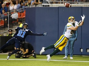 Edmonton Eskimos' Greg Ellingson makes a diving touchdown catch against Toronto Argonauts' Qudarius Ford during the second half of CFL football action in Toronto, Friday August 16, 2019.