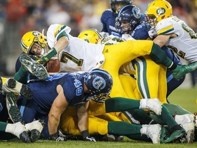 Edmonton Eskimos quarterback Trevor Harris jumps over the line against the Toronto Argonauts during the second half of CFL football action in Toronto, on Friday, Aug. 16, 2019.