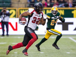 Ottawa Redblacks' John Crockett (32) is followed by Edmonton Eskimos' Anthony Orange (24) during first half CFL action in Edmonton on Friday, August 9, 2019.