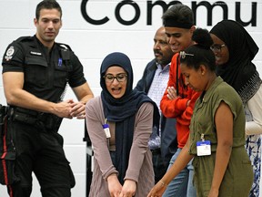 Misk Al Fadli pulls a 68 kg. mannequin for 15 meters at the Edmonton Police Service downtown headquarters on Monday August 12, 2019. She was participating in the Police-Youth Engagement Program along with other 14-17 years-old youth from the Oromo, Sudanese, Somali, Eritrean, Ethiopian, Syrian and Iraqi communities for a two-week long summer program that strives to build mutual understanding and positive relationships between youth and police. (PHOTO BY LARRY WONG/POSTMEDIA)