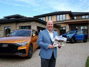 Stollery Children's Hospital Foundation President and CEO Mike House poses for a photo outside the Mighty Millions Lottery $2.4 million grand prize showhome, in Edmonton Thursday Aug. 22, 2019.