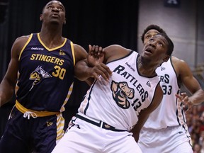 Edmonton Stingers forward Travis Daniels, left, battles for a rebound with Saskatchewan Rattlers forward Shaquille Keith at the Edmonton Expo Centre on Thursday, Aug. 8, 2019.