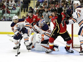 Steven Iacobellis of the Edmonton Oilers works to clear a rebound away from goaltender Dylan Wells while teammate Dmitri Samorukov keeps Calgary Flame Cameron Hebig busy  during the Young Guns Battle of Alberta game on Sept. 7, 2019, at the Centrium in Red Deer.