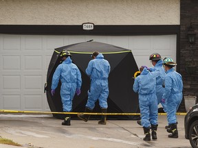 Edmonton Fire Rescue Services investigators and Edmonton Police Service officers are on scene of a fatal house fire at 76 Street and 157 Avenue NW in Edmonton, on Wednesday, Sept. 18, 2019. Photo by Ian Kucerak/Postmedia