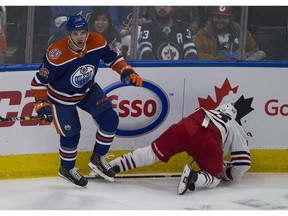 Edmonton Oilers Brandon Manning (26) flattens Winnipeg Jets Brandon Tanev (13) during first period NHL action on Monday, Dec. 31, 2018 in Edmonton.