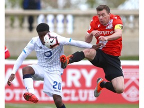 FC Edmonton Bruno Zebie (L) competes with Cavalry FC Nik Ledgerwood during second half CPL soccer action between FC Edmonton and Cavalry FC in Calgary at Atco Field at Spruce Meadows on Saturday, May 18, 2019. Cavalry won 1-0 and remain undefeated.