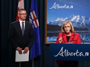 Former Saskatchewan finance minister Janice MacKinnon speaks on the report she chaired on the state of Alberta's finances at the McDougall Centre in Calgary on Tuesday September 3, 2019. Finance Minister Travis Toews listens in the background.