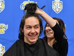 UPLOADED BY: Derek  Van Diest  ::: EMAIL: dvandiest@postmedia.com ::: PHONE: 780-868-6838  ::: CREDIT: Andy Devlin / Edmonton Oil Kings ::: CAPTION: Edmonton Oil Kings forward Jalen Luypen gets ready to get his hair cut after raising $5,450 for Kids Cancer Care at Rogers Place on Sept. 18, 2019.