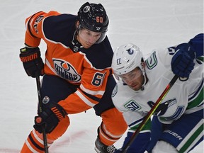 Edmonton Oilers forward Markus Granlund battles with Vancouver Canucks counterpart Josh Leivo during NHL pre-season action at Rogers Place in Edmonton on Sept. 19, 2019.
