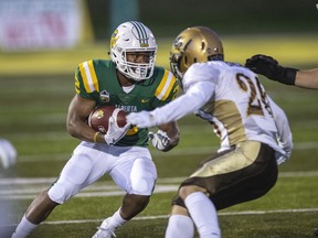 University of Alberta Golden Bears running back Jonathan Rosery, left, runs the ball against University of Manitoba Bisons safety Austin Balan in Canada West Conference play at Foote Field on Friday, Sept. 13, 2019.