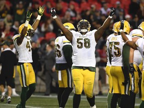 Edmonton Eskimos offensive lineman Travis Bond (58) celebrates as officials announce that wide receiver Tevaun Smith's (4), not shown, touchdown against the Ottawa Redblacks was good during second half CFL football action in Ottawa on Saturday, Sept. 28, 2019.