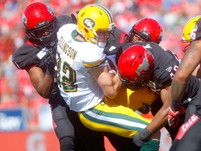 The Calgary Stampeders' defence stops Edmonton Eskimos receiver Greg Ellingson in first half action on Sept. 2, 2019,  in the Labour Day Classic at Calgary's McMahon Stadium.