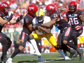 The Calgary Stampeders defence stops DaVaris Daniels of the Edmonton Eskimos in the Labour Day Classic in Calgary on Sept. 2, 2019.