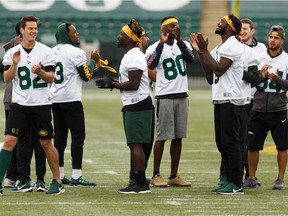 Players share a moment during an Edmonton Eskimos practice at Commonwealth Stadium ahead of their Sept. 7 game against the Calgary Stampeders in Edmonton on Friday, Sept. 6, 2019.