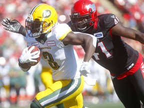 Cordarro Law of the Calgary Stampeders  stops Natey Adjei of the Edmonton Eskimos in first half action of the Labour Day classic at McMahon Stadium in Calgary on Monday, Sept. 2, 2019.