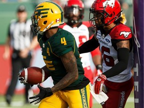 Edmonton Eskimos' Tevaun Smith (4) scores a touchdown as Calgary Stampeders' Wynton McManis (48) reacts during the first half of CFL football action at Commonwealth Stadium in Edmonton on Saturday, Sept. 7, 2019.