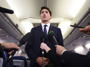 Liberal Leader Justin Trudeau makes a statement in regards to photo coming to light of himself from 2001 wearing "brownface" during a scrum on his campaign plane in Halifax, N.S., on Wednesday, September 18, 2019.