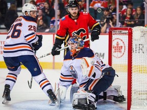 Edmonton Oilers goaltender Mikko Koskinen (19) makes a save against the Calgary Flames during the first period at Scotiabank Saddledome.