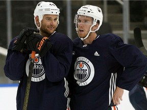 Edmonton Oilers Zack Kassian, left, and Connor McDavid take a break during training camp in Edmonton on Friday, Sept. 13, 2019.