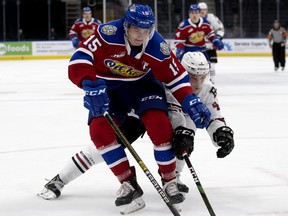 Edmonton Oil Kings' Scott Atkinson (15) battles the Red Deer Rebels' Christoffer Sedoff (4) during first period WHL action at Rogers Place, in Edmonton Sunday Sept. 22, 2019. Photo by David Bloom