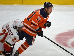 Edmonton Oilers Anton Burdasov (71) heads up ice with Calgary Flames Devante Smith-Pelly (21) during pre-season NHL action at Rogers Place in Edmonton, September 20, 2019.