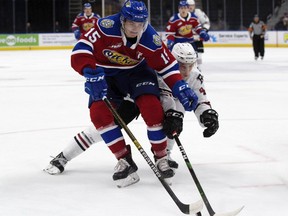 Edmonton Oil Kings' Scott Atkinson (15) battles the Red Deer Rebels' Christoffer Sedoff (4) during first period WHL action at Rogers Place, in Edmonton Sunday Sept. 22, 2019.