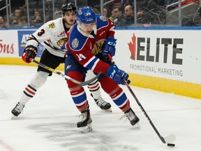 Edmonton Oil Kings'  Josh Williams (14) battles Portland Winterhawks' Nick Perna (3) during WHL hockey action at Rogers Place in Edmonton, on Sunday, Oct. 13, 2019.