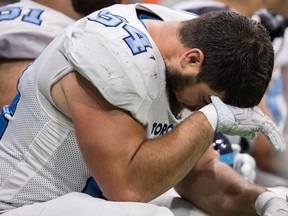Toronto Argonauts' Ryan Bomben wipes his forehead with the back of his glove as he sits on the bench during second half CFL football action against the B.C. Lions, in Vancouver, Saturday, Oct. 5, 2019. THE CANADIAN PRESS/Darryl Dyck