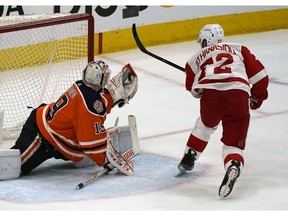 Edmonton Oilers goalie Mikko Koskinen (left) makes a glove save on Detroit Red Wings Andreas Athanasiou (right) during first period NHL hockey game action in Edmonton on Tuesday January 22, 2019.