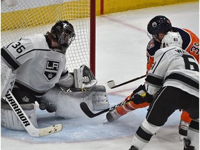 Edmonton Oilers Alex Chiasson (39) tries to 5-hole the puck past Los Angeles Kings goalie Jack Campbell (36) with Wyatt McLeod (6) on him during NHL action at Rogers Place in Edmonton, March 26, 2019.
